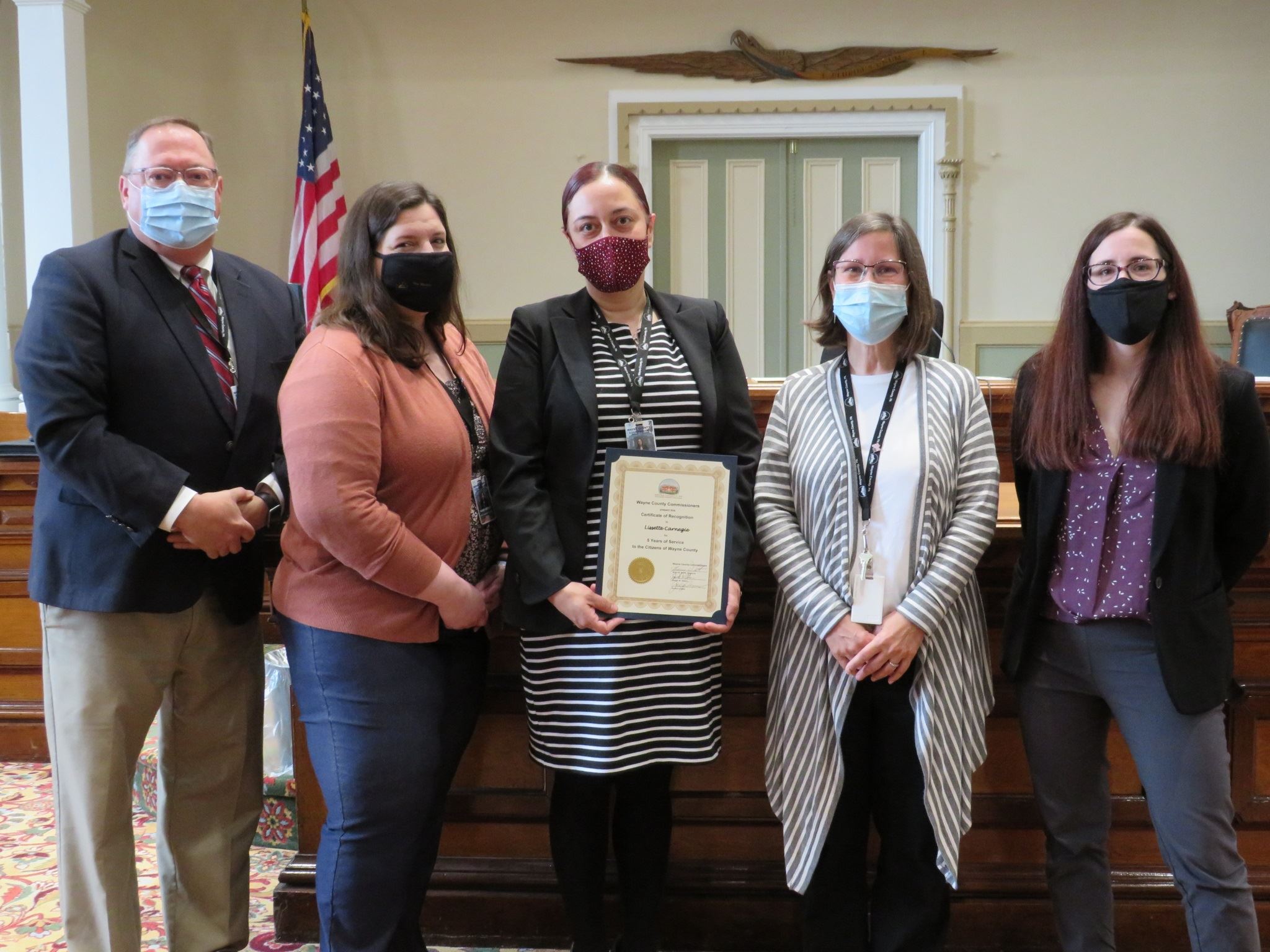 Lisette Carnegie  with the Commissioners marking five year of service to the people of Wayne County.