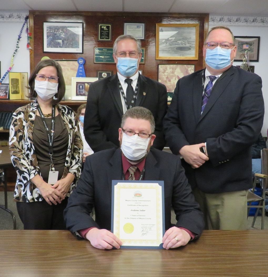Andrew Seder  with the Commissioners marking one year of service to the people of Wayne County.